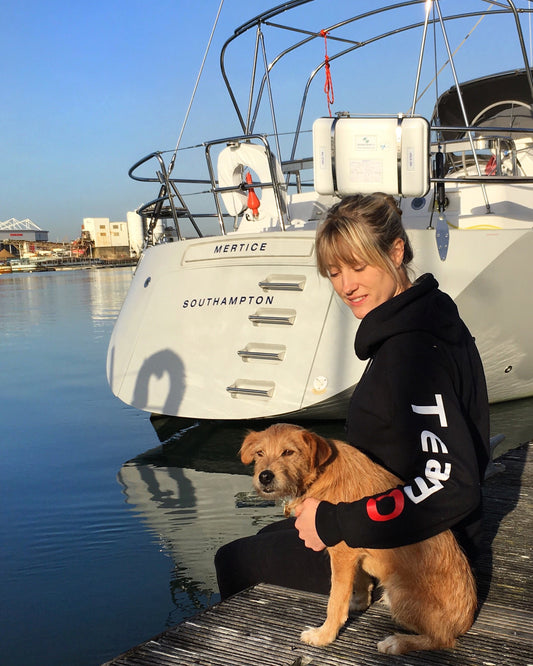 TeamO Marine Sailing Lifejacket Business, TeamO Hoodie on the dock with dog