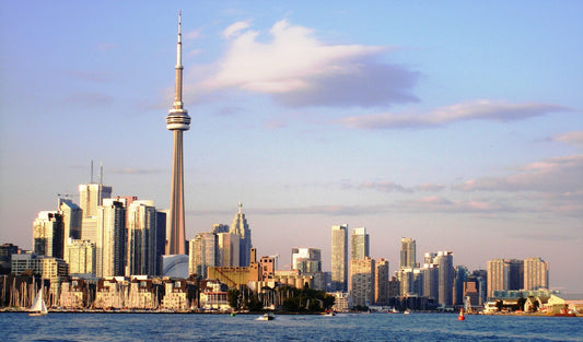 TeamO Marine BackTow lifejackets now available in Canada. The image shows the city skyline of Toronto from the water from a sailing boat.
